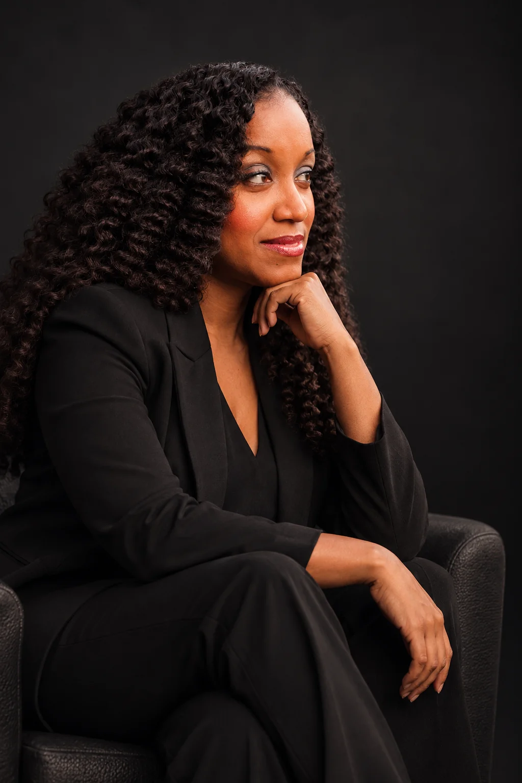 Founder of The Hybrid Techie in a thoughtful seated portrait